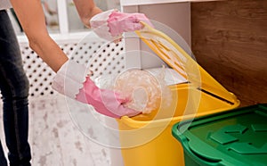 Young girl sorting garbage at the kitchen. Concept of recycling. Zero waste