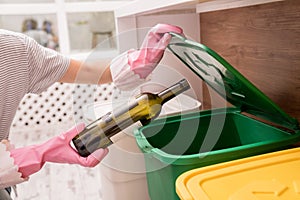 Young girl sorting garbage at the kitchen. Concept of recycling. Zero waste