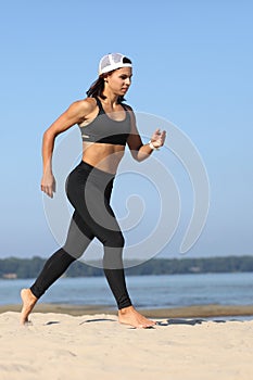 Young woman jogging by the sea photo