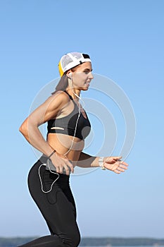 Young woman jogging by the sea photo