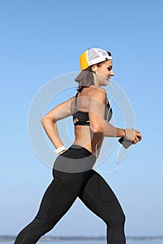 Young woman jogging by the sea photo