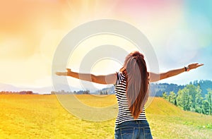 Young girl spreading hands with joy and inspiration