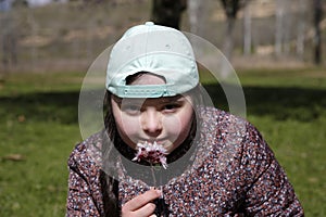 Young girl with spring flowers in her hand