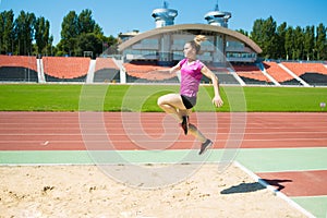 Young girl in the stadium jumping