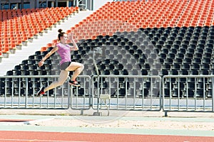 Young girl in the stadium jumping