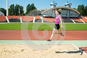 Young girl in the stadium jumping