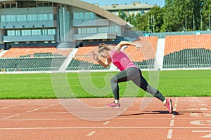 A young girl in the stadium runs