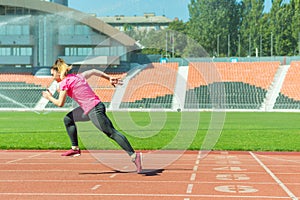 A young girl in the stadium runs