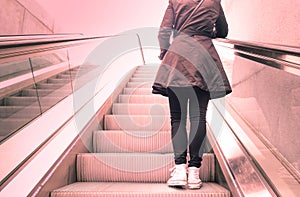 Young girl standing on escalators stairway