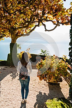 Young girl standing on the pathway in park of Villa Balbianello