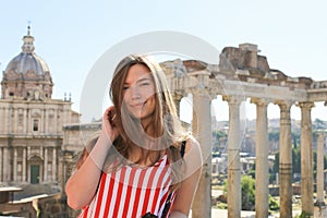 Young girl standing in ruins of Roman Forum background in Rome, Italy.