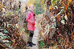 The young girl stands in the woods and smiles, she is glad she found her way home, because before that she was lost and crying