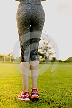 Young girl is stretching before running, training concept