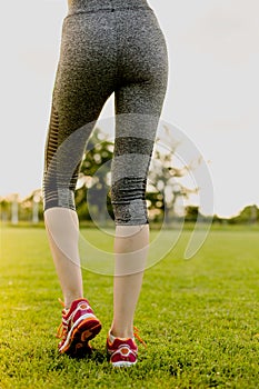 Young girl is stretching before running, training concept