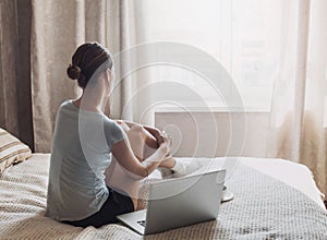 Young girl or student using laptop at home. Woman working on computer