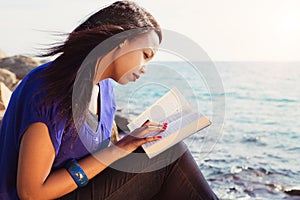 Young Girl Studying Her Bible By The Sea