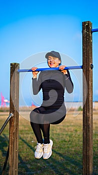 young girl suffering doing pullups