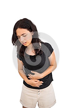 Young girl suffers from abdominal pain. Menstrual pain in teenagers. Woman holding her stomach in pain