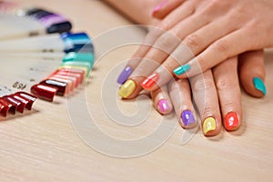 Young girl summer colored manicure.