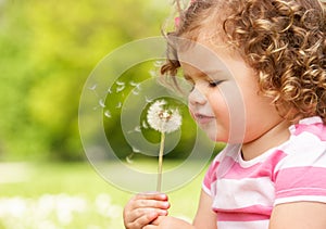 Young Girl In Summer Dress Sitting In Field