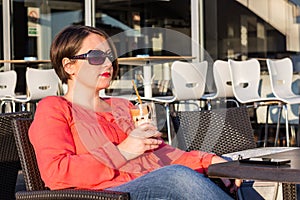 Young Girl With Sunglasses Drinking Coffee and Enjoying Beautiful Sunny Day Outside