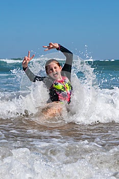 Young girl in surf at Makorori Beach, near Gisborne, New Zealand