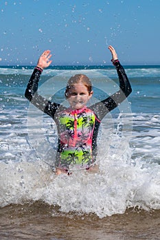 Young girl in surf at Makorori Beach, near Gisborne, New Zealand