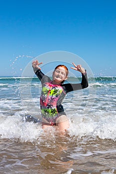 Young girl in surf at Makorori Beach, near Gisborne, New Zealand