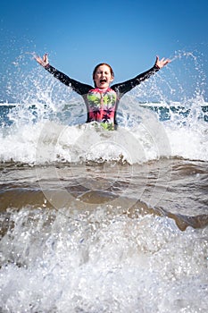 Young girl in surf at Makorori Beach, near Gisborne, New Zealand