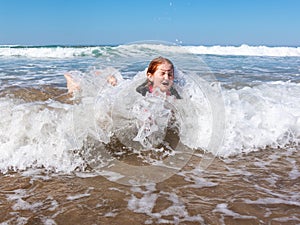 Young girl in surf at Makorori Beach, near Gisborne, New Zealand