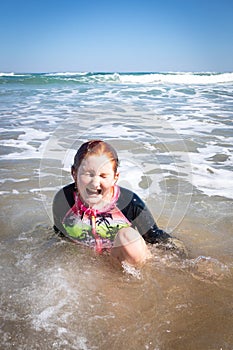 Young girl in surf at Makorori Beach, near Gisborne, New Zealand