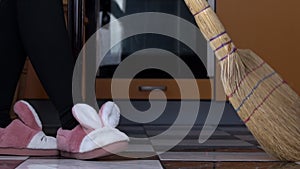 Young Girl Sweeps the Floor in the Kitchen with an Ordinary Broom in Slow Mo