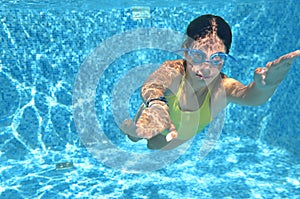 Young girl swimmer swimming under water in pool and has fun, teenager diving underwater, family vacation, sport and fitness