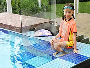 Young girl by swimming pool