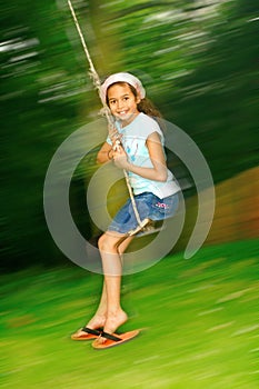 Young girl swinging fast