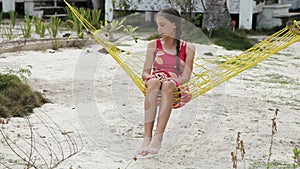 Young girl swinging in a hammock