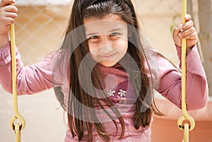 A young girl on the swings