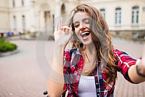 Young girl take selfie from hands with phone with okay sign on s