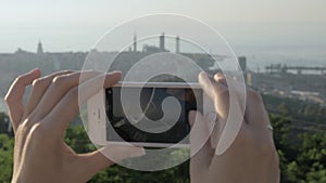 Young girl takes a picture of the city Batumi on the Black see, Georgia