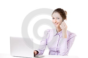 Young girl taking business call in front of laptop