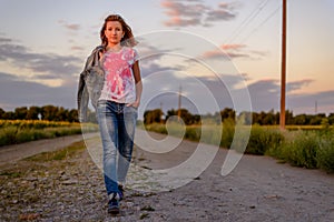 Young girl taking an evening walk in the country