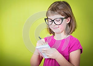 Young girl taking notes