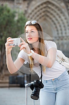 Young girl is taking photo on her phone