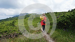 Young girl taking a photo at the mountains