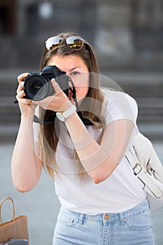 Young girl is taking photos on her camera
