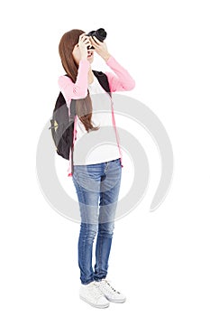 Young girl taking a picture using digital camera