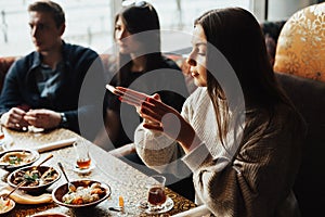 Young company is having fun and eating in bar. smoking a hookah, communicating in an oriental restaurant.