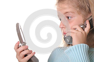Young girl talking on a cell phone looking at anot