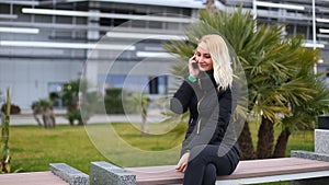 Young girl talking on mobile cell phone smiling, outdoors. Happy Woman