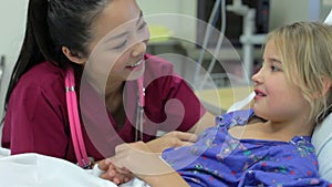 Young Girl Talking To Female Nurse In Intensive Care Unit